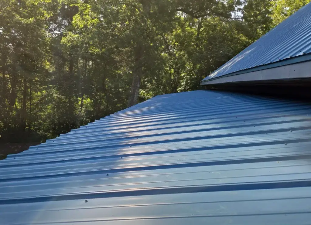 Expertly installed metal roof boasts a vibrant blue color, enhancing aesthetics.